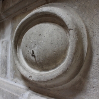 Detail of a French country style original antique fireplace surround in limestone