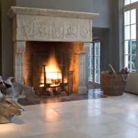 Beautiful country fireplace surround in limestone on a Black Belgian marble border.