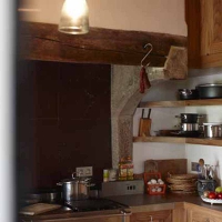 Beautiful antique fireplace surround from the 15th century in limestone in a French Country Design Kitchen 