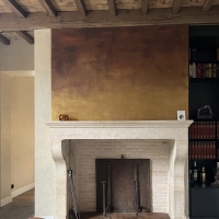 Antique limestone fireplace mantle from a French castle with cast iron plates and French floors